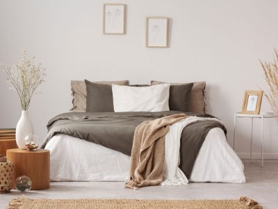 Spacious bedroom interior in beige and olive colour