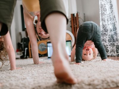 Family Doing Home Workout Online Class A mother does a virtual exercise class with her daughters in their living room. Part of the regular routine or the new normal with social distancing and Covid-19.