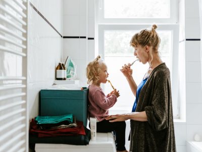 Young mother with a child brushing teeth in the morning Photo series of a young mother with a child doing different chores at home. Shot in Berlin.