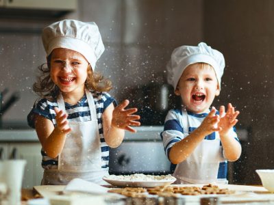 happy family funny kids bake cookies in kitchen happy family funny kids are preparing the dough, bake cookies in the kitchen
