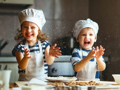 happy family  funny kids are preparing the dough, bake cookies in the kitchen